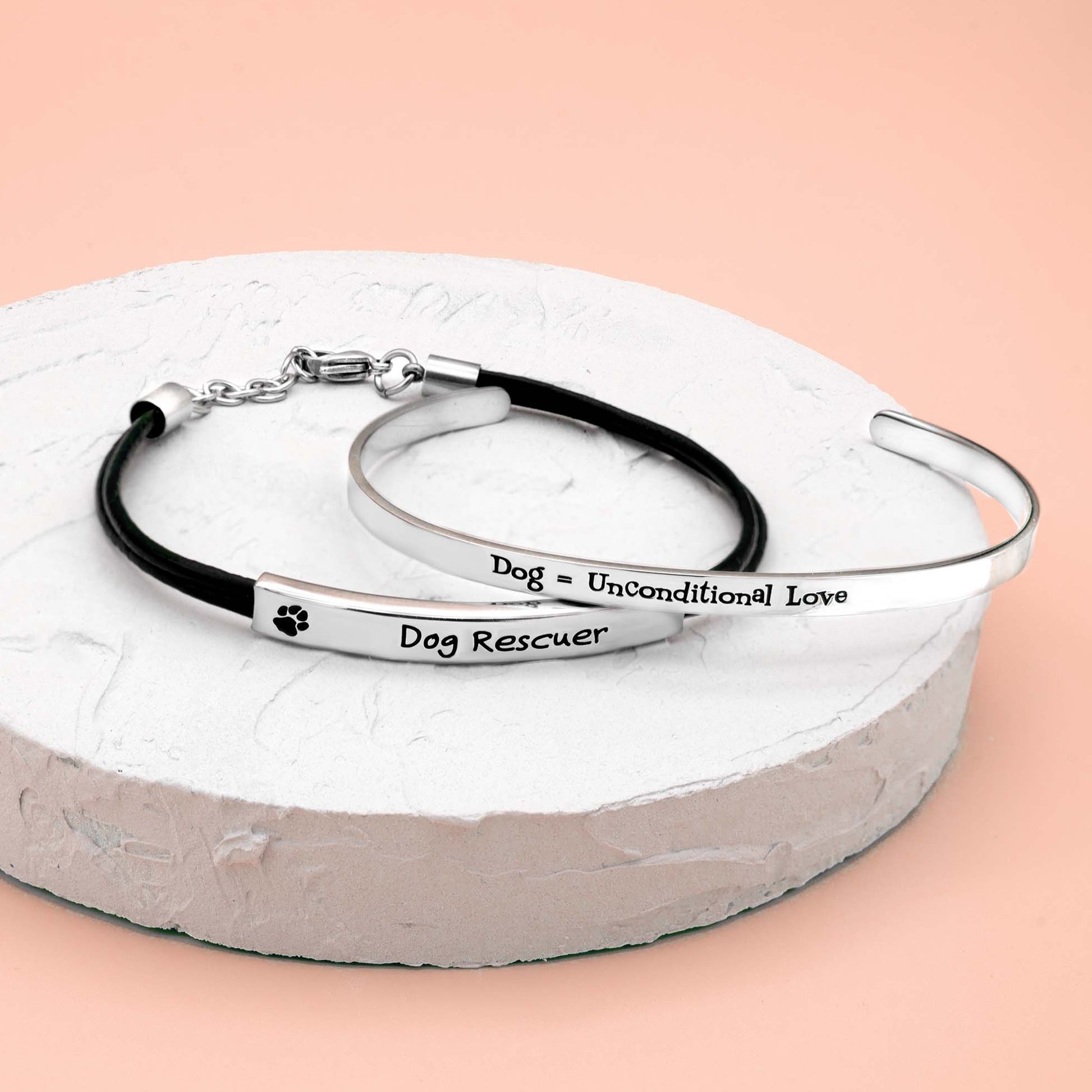 Stainless steel cuff bracelet with the inscription 'Dog, Unconditional Love' surrounded by paw prints.