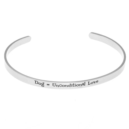 Stainless steel cuff bracelet with the inscription 'Dog, Unconditional Love' surrounded by paw prints.