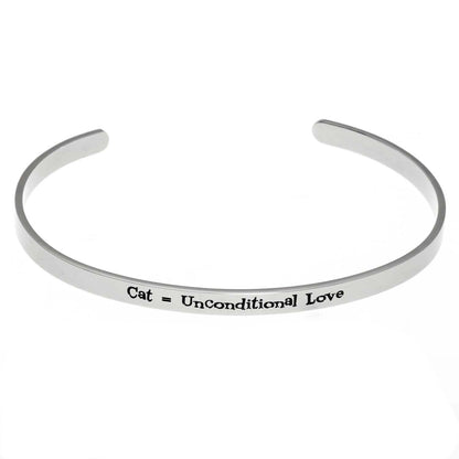 Stainless steel cuff bracelet with the inscription 'Cat, Unconditional Love' surrounded by paw prints.