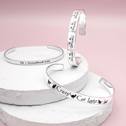 Stainless steel cuff bracelet with minimalist cat face and whiskers design, featuring the inscription 'Cat lady' on the inside.