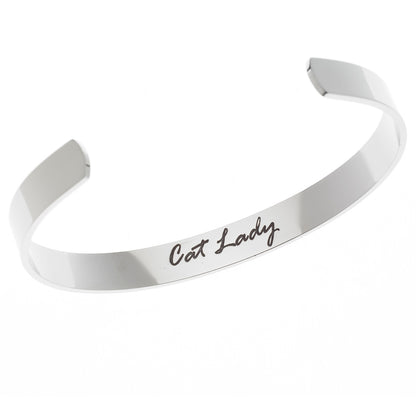 Stainless steel cuff bracelet with minimalist cat face and whiskers design, featuring the inscription 'Cat lady' on the inside.