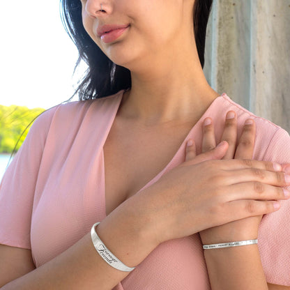 Inspirational stainless steel cuff bracelet with engraved words 'Forever Friends' on the outside. Adjustable and hypoallergenic, perfect as a thoughtful gift for friends.