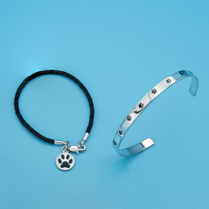 Stainless steel cuff bracelet with a minimalistic pet paw print design, featuring the inscription 'Unconditional Love' on the inside.