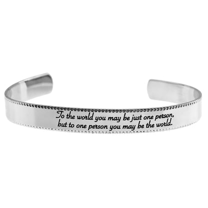 Stainless steel cuff bracelet with engraved words 'To the world you may be just one person, but to one person you may be the world'—a symbol of love and significance. Adjustable and crafted with high-quality materials.