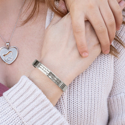 Stainless steel cuff bracelet with engraved words 'To the world you may be just one person, but to one person you may be the world'—a symbol of love and significance. Adjustable and crafted with high-quality materials.