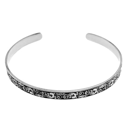 Inspirational stainless steel cuff bracelet with an elegant Victorian flower design on the outside and engraved words 'My maid of honor today, my sister forever' on the inside. Adjustable and hypoallergenic, perfect as a thoughtful gift for sisters and symbolizing the enduring bond of sisterhood.